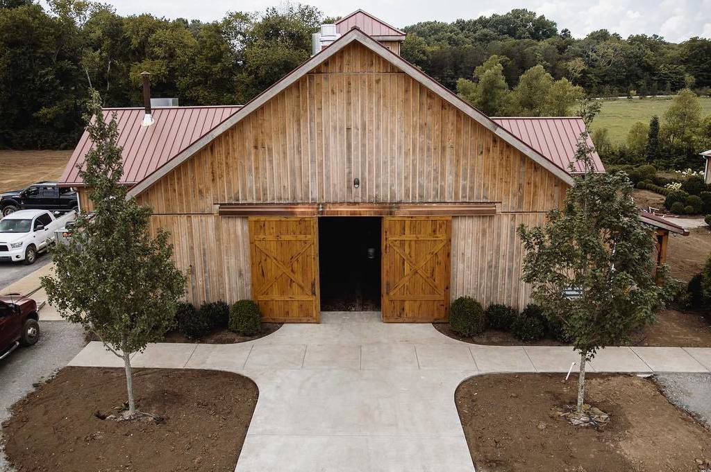 Board-and-batten gable end and sliding barn doors on the production wing
