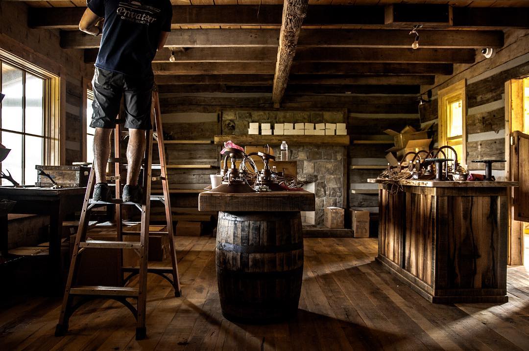 Finish carpenter working above the tasting bar during buildout
