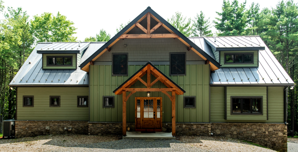 Reclaimed hand-hewn barn timbers stacked in the yard