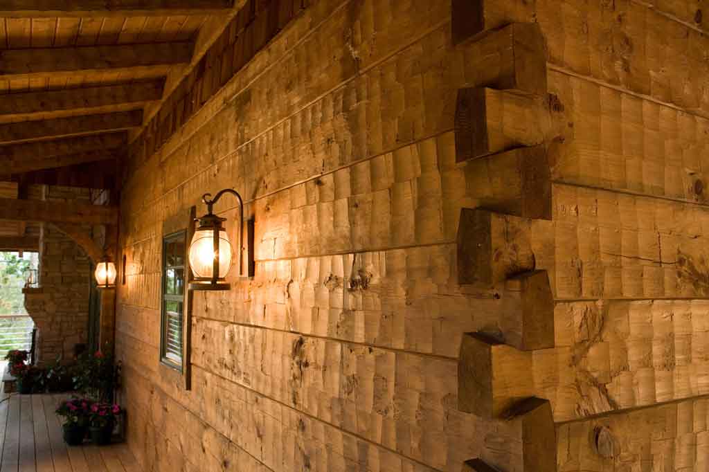 Hand-hewn log wall with dovetailed corner notching and chinking