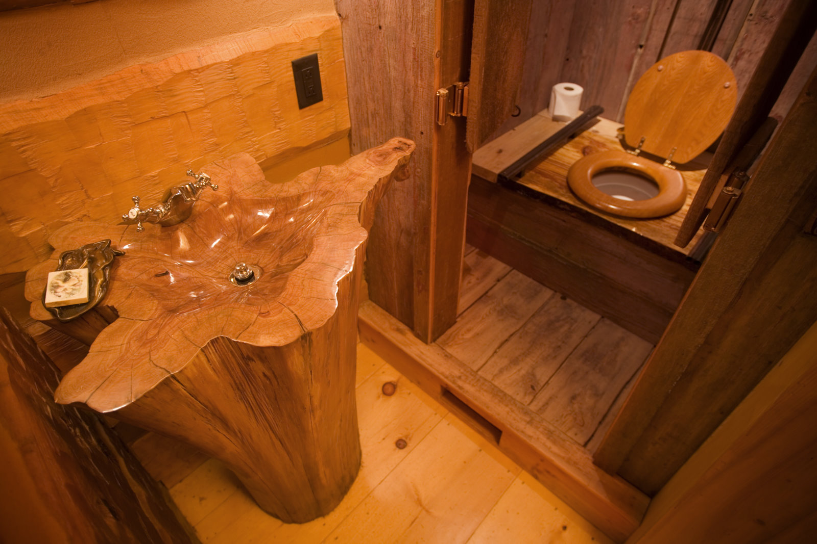 Powder room with a sink carved from a single cypress stump